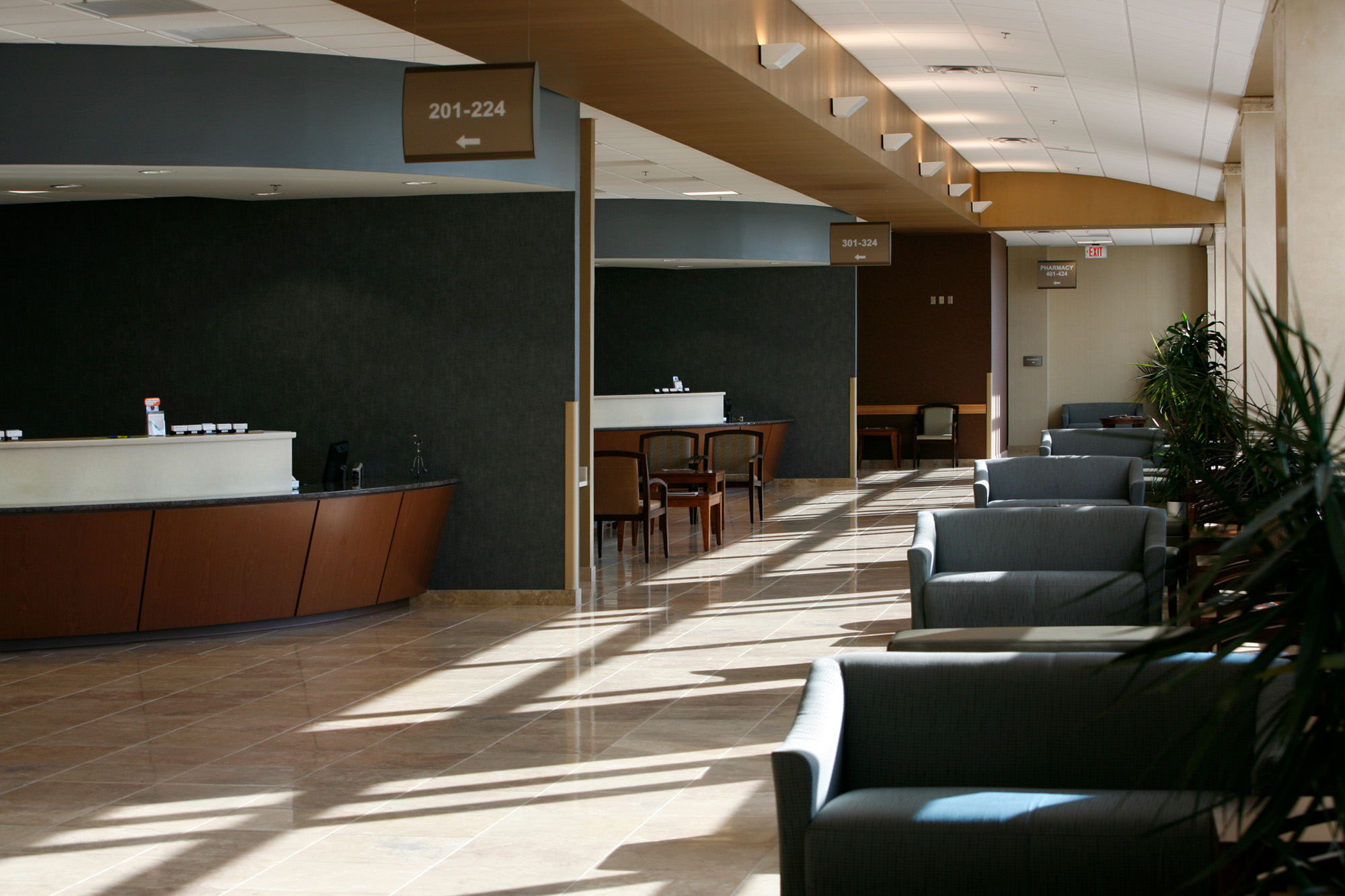 Clinic waiting area with reception desks and seating